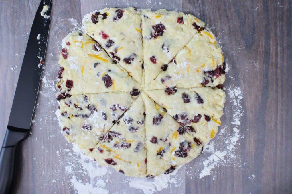 pat cranberry orange dough into a circle and cut into even slices