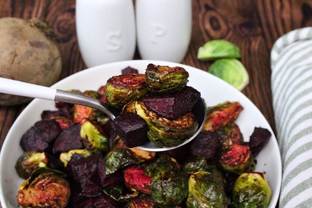 spoonful of roasted air fryer beets and brussels sprouts