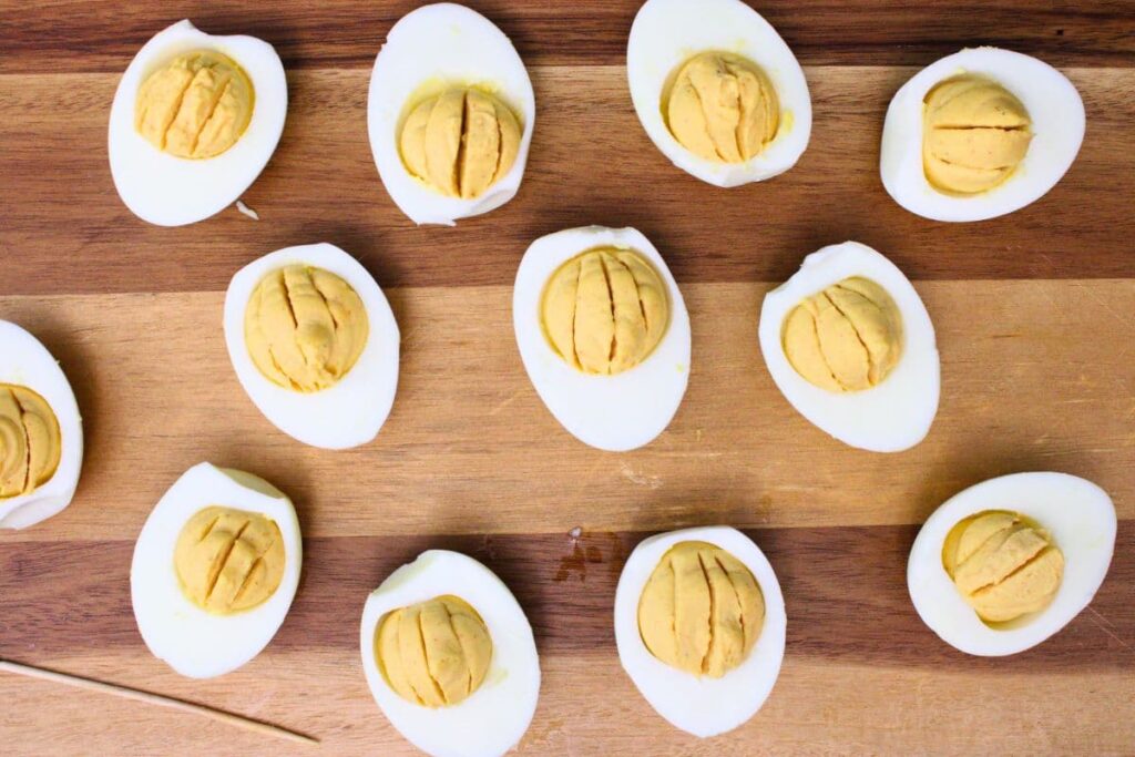 use a toothpick to add vertical lines to egg filling