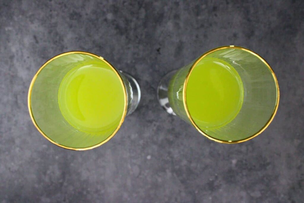 add orange juice and hpnotiq vodka to champagne flute