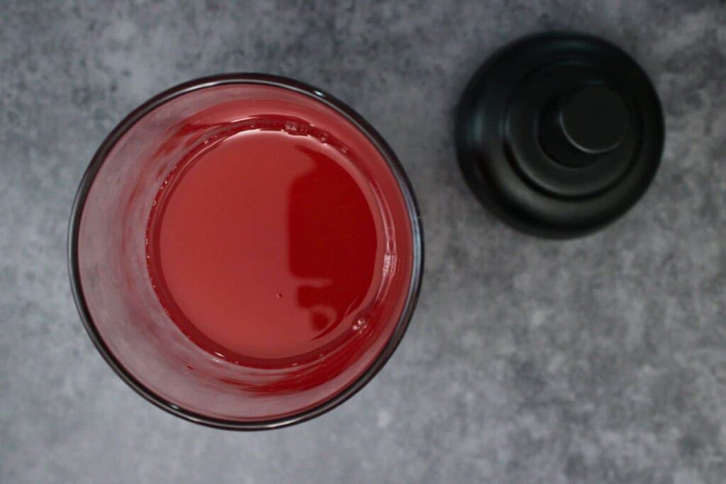 add vodka, cranberry juice, grenadine, and sour mix to cocktail shaker