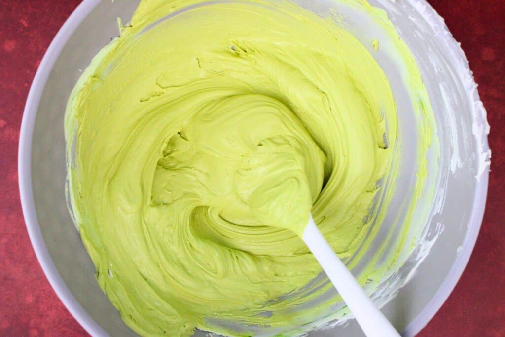 melt second bag of white chocolate chips and add green and yellow food coloring