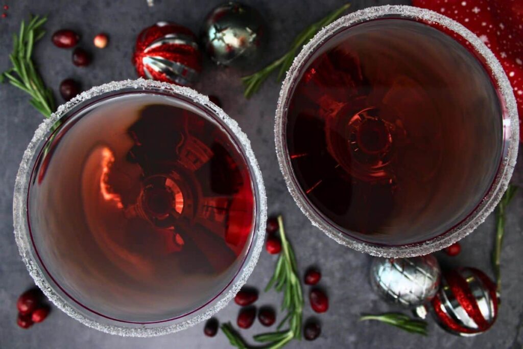 overhead view of two santa clausmopolitan drinks with sugar rims