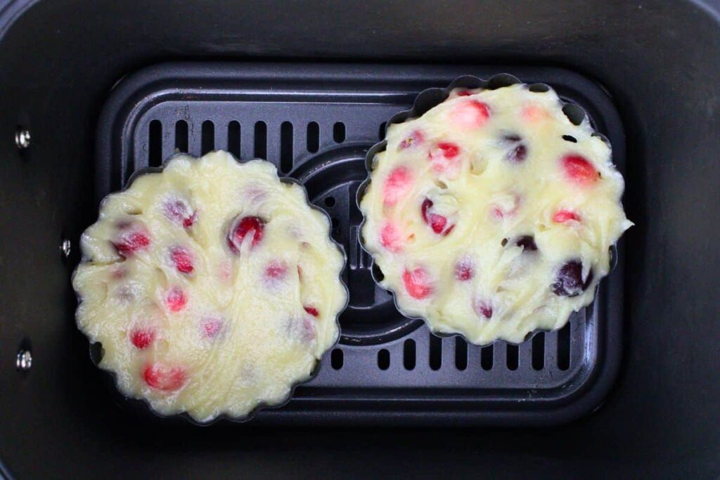 place mini filled cranberry pie tart pans in air fryer basket