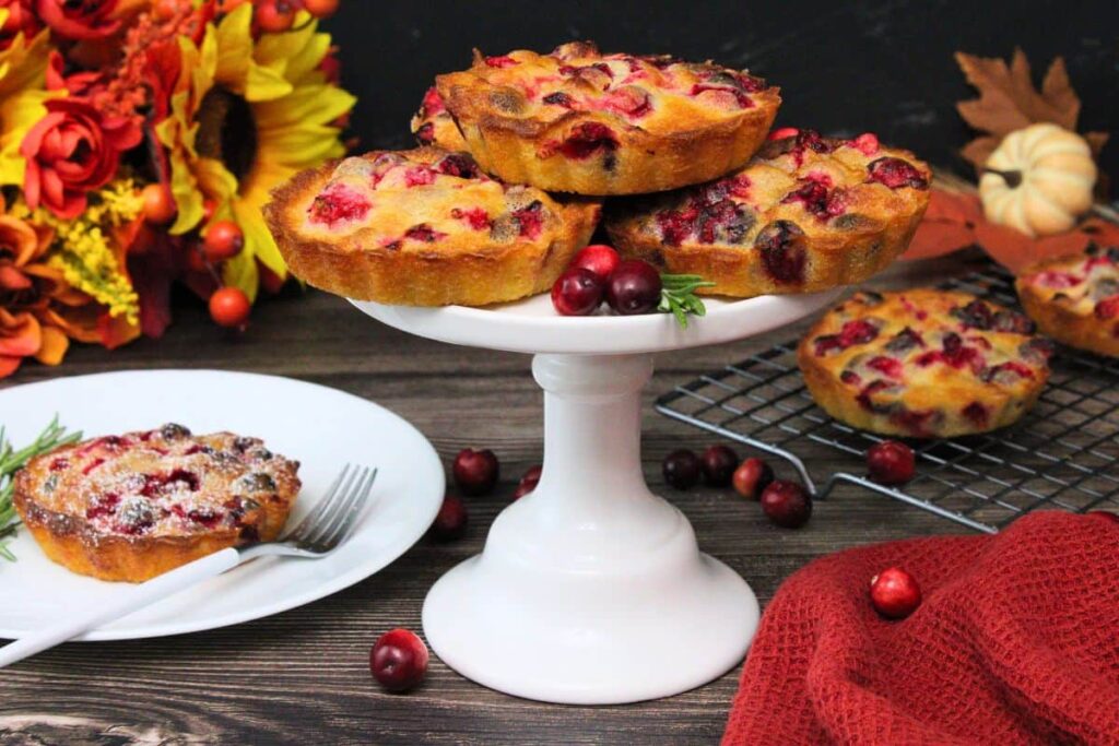 several crustless cranberry pies on a stand with additional pies cooling on a wire rack