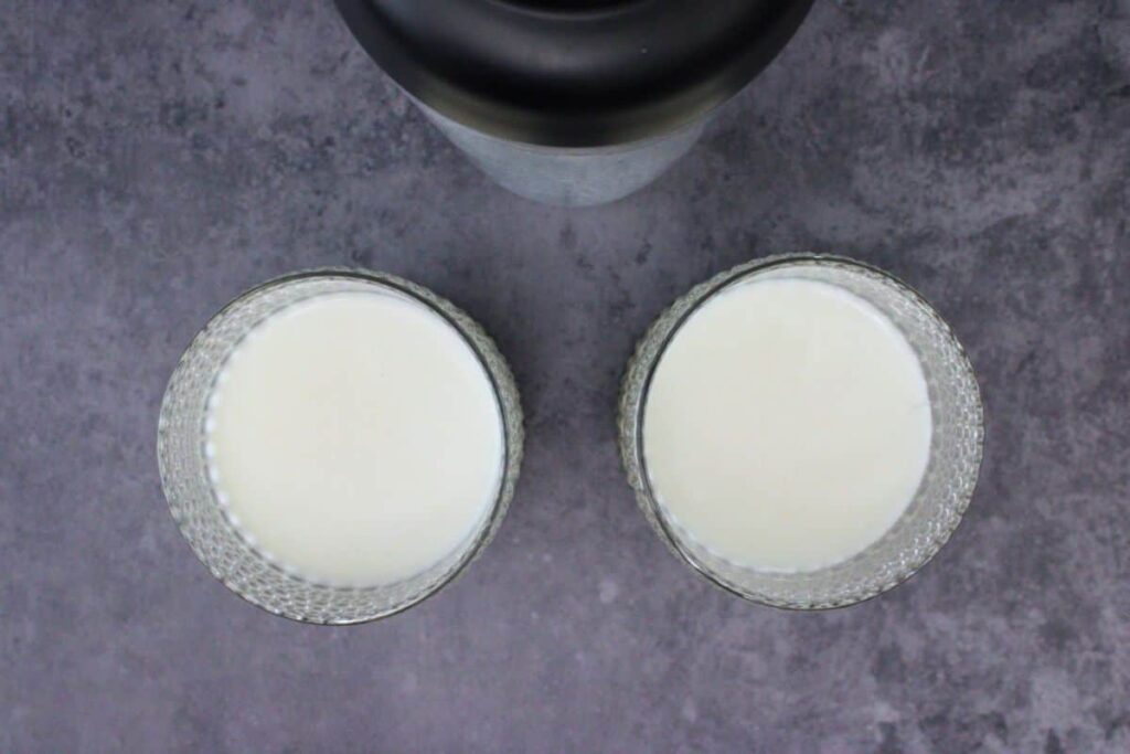 shake and strain chilled white christmas punch into glasses