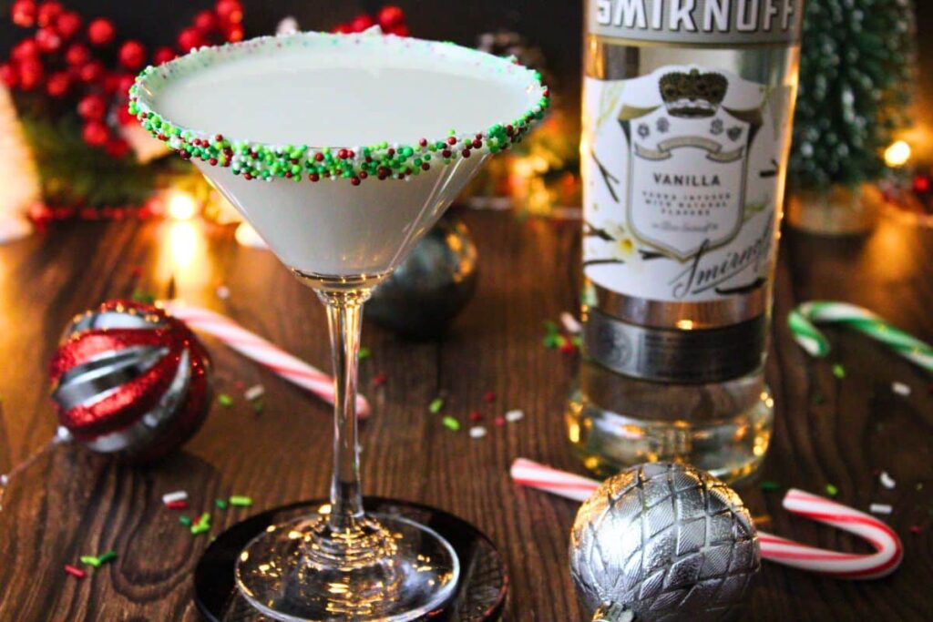 sugar cookie martini next to vodka bottle in holiday setting