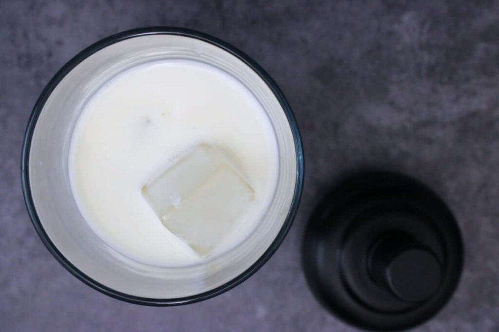 add vanilla vodka, white chocolate liqueur, and half and half to cocktail shaker