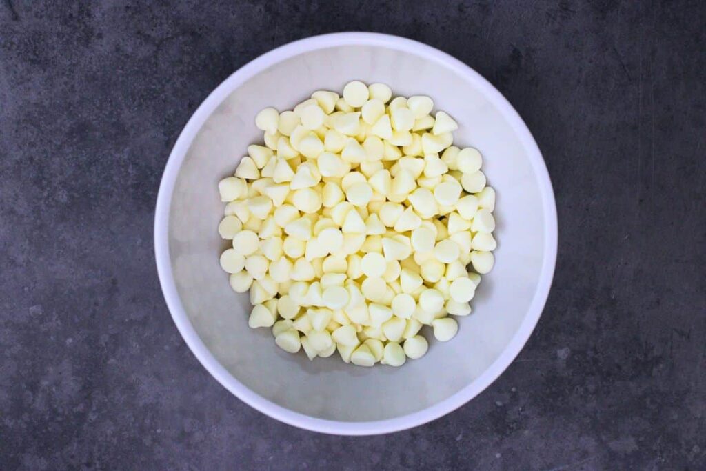 add white chocolate chips for snowflake pretzels to microwave safe bowl