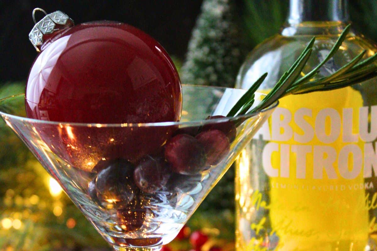 closeup of ornament martini with glass bauble in front of vodka bottle