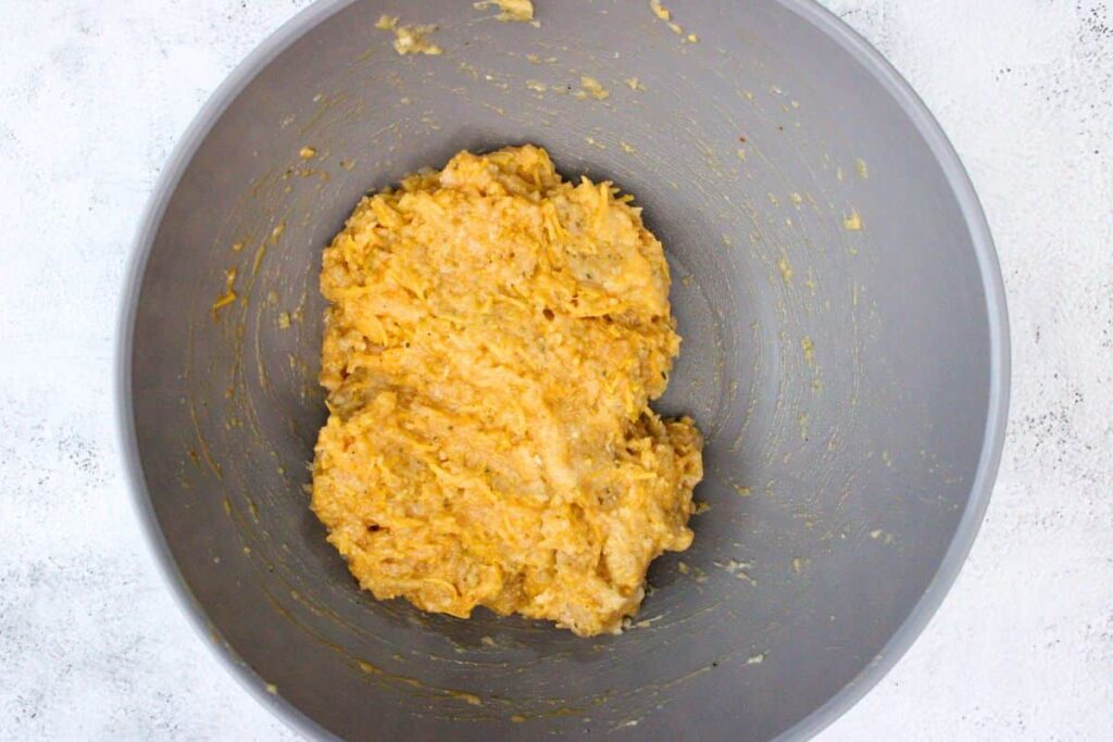 combine chicken, panko bread crumbs, egg, ranch seasoning, cheddar cheese, wing sauce, salt, and pepper in a large bowl
