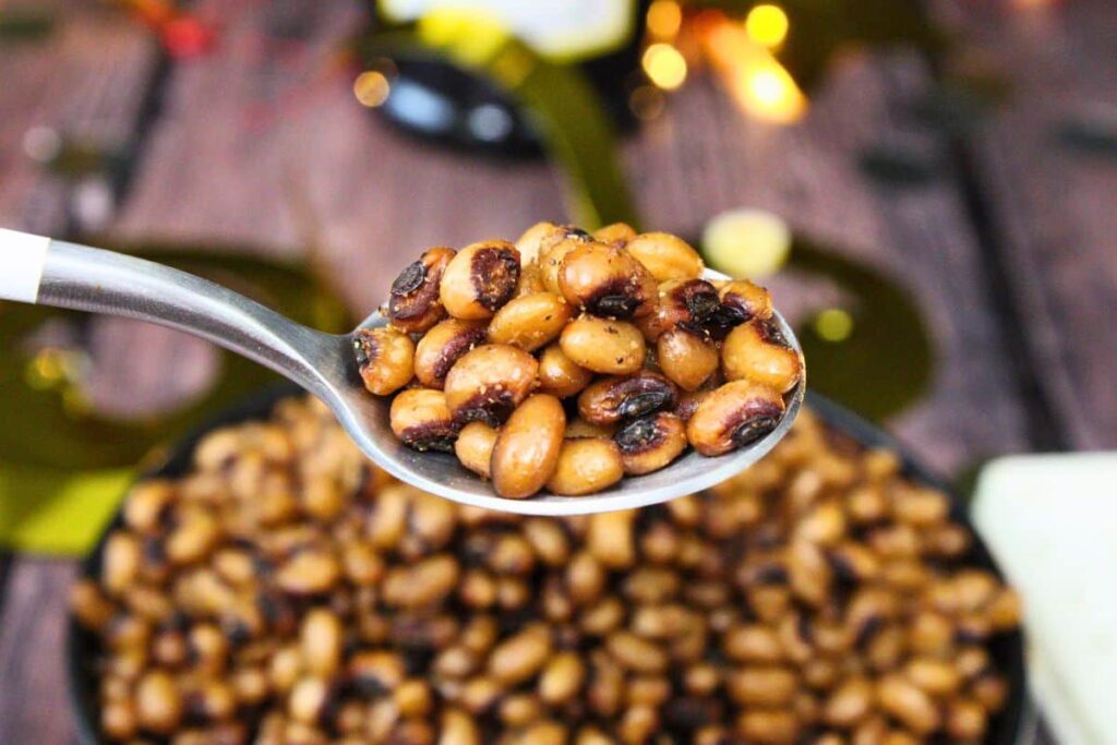 holding up a spoonful of air fryer black eyed peas