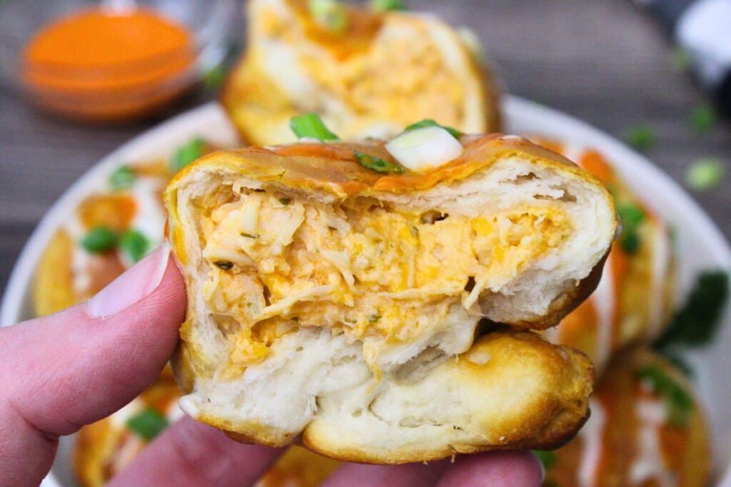 holding up half of a buffalo chicken bomb to show the inside