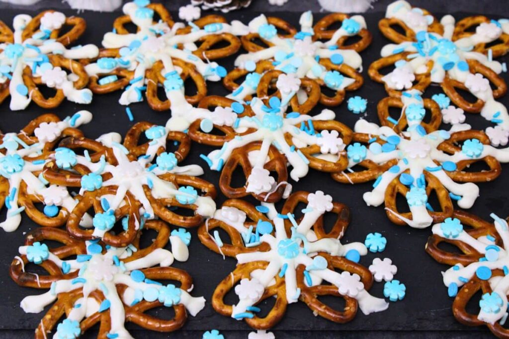 holiday snowflake pretzels spread across black slate