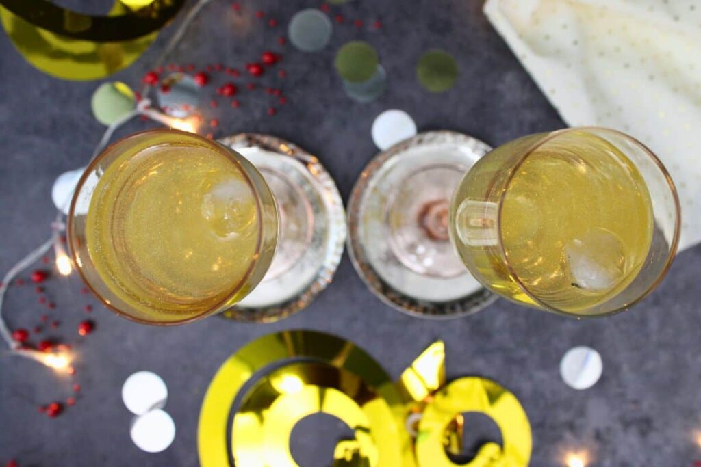 overhead view of two glitter ball cocktails surrounded by new years decorations