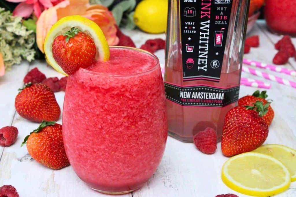 pink whitney slushie frozen cocktail next to pink whitney bottle
