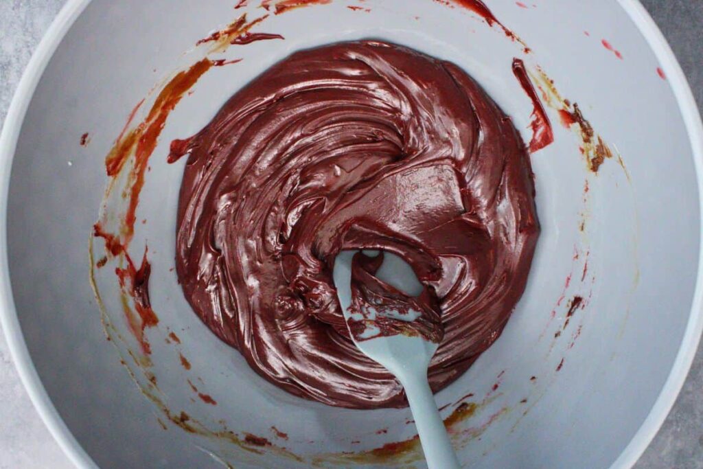 stir in teaspoon of vanilla extract, salt, and red gel food coloring