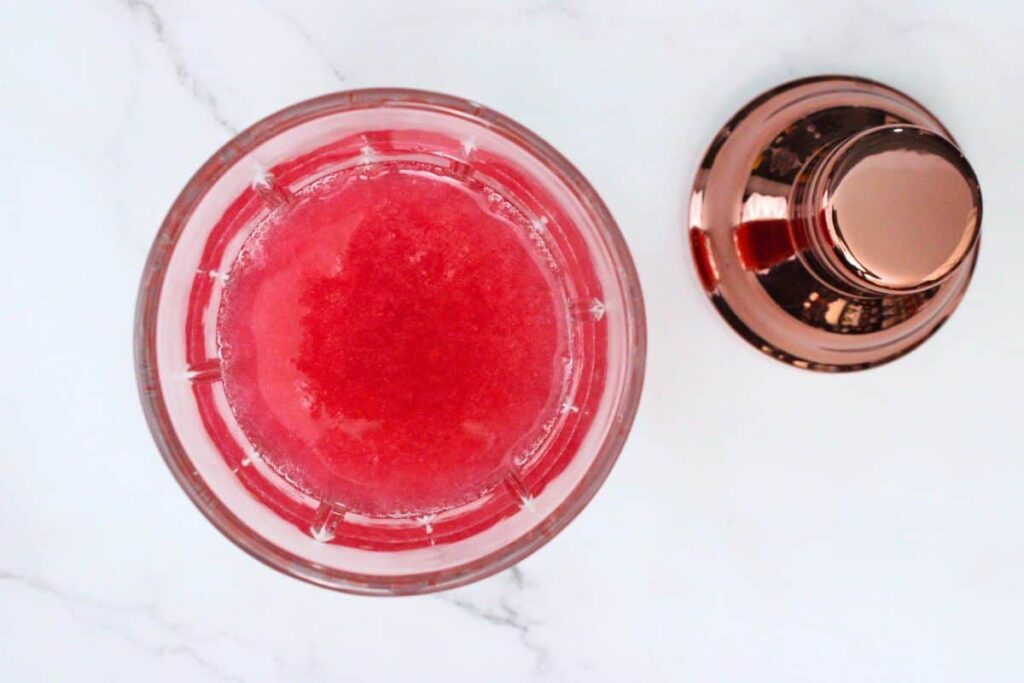 add vodka, lemon juice, simple syrup, agave syrup, and water to muddled raspberries