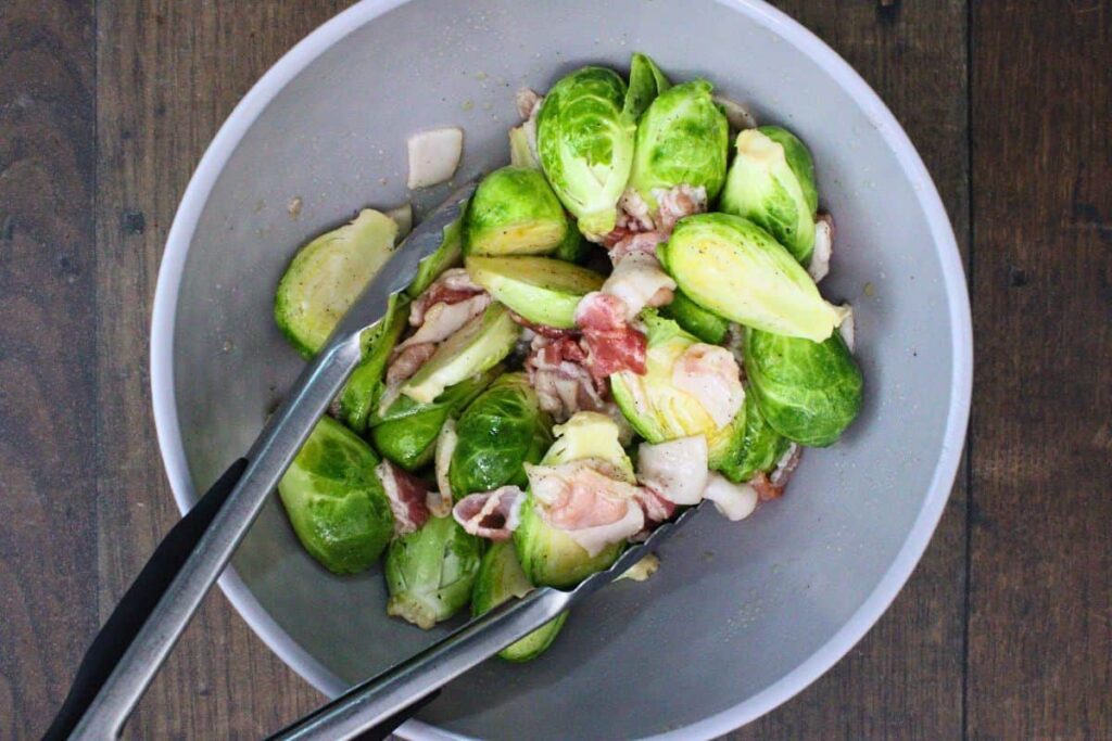 combine brussel sprouts with olive oil maple syrup and bacon pieces