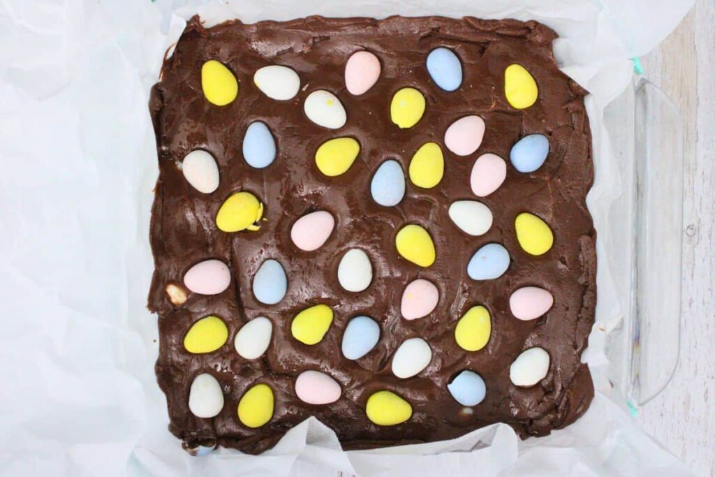 pour fudge mixture into prepared pan then add remaining eggs on top
