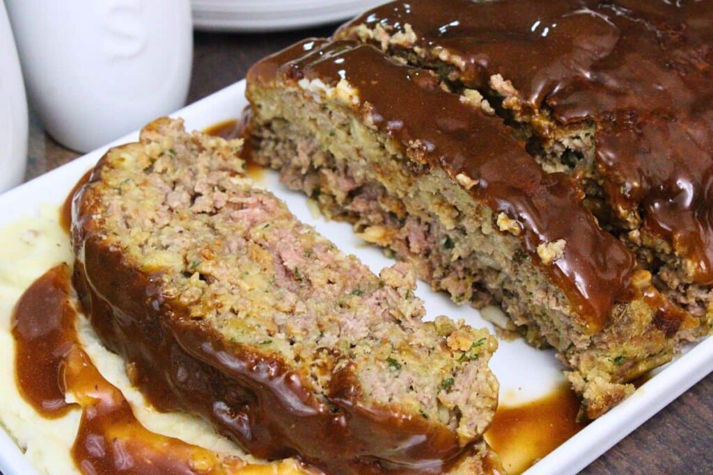 closeup view of stove top stuffing meatloaf slices and covered in gravy