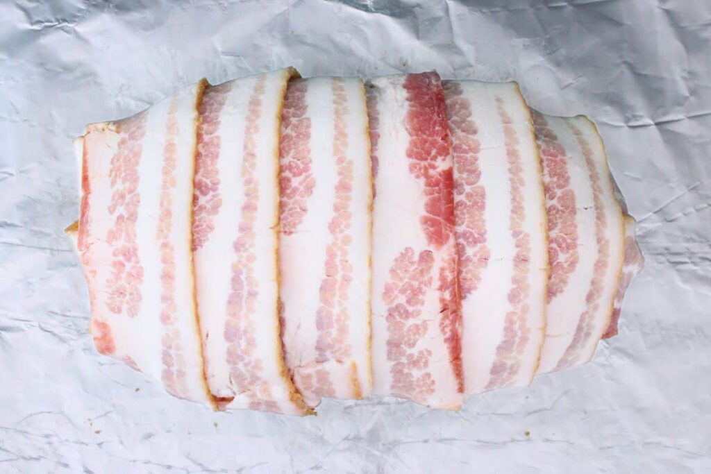 cover meatloaf with bacon strips lengthwise and crosswise
