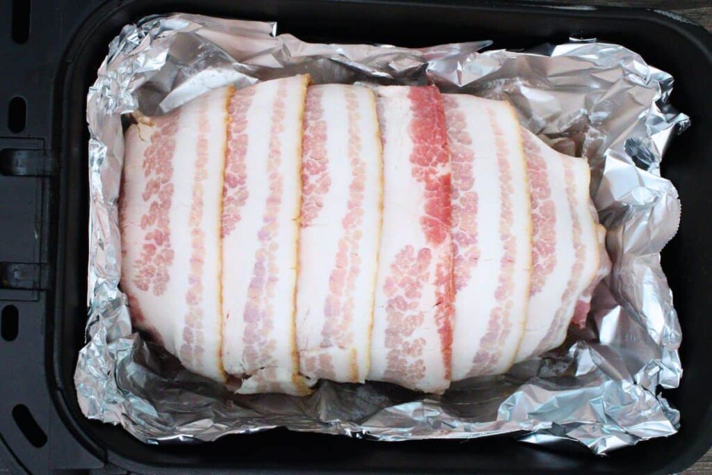 place bacon wrapped meatloaf in air fryer basket