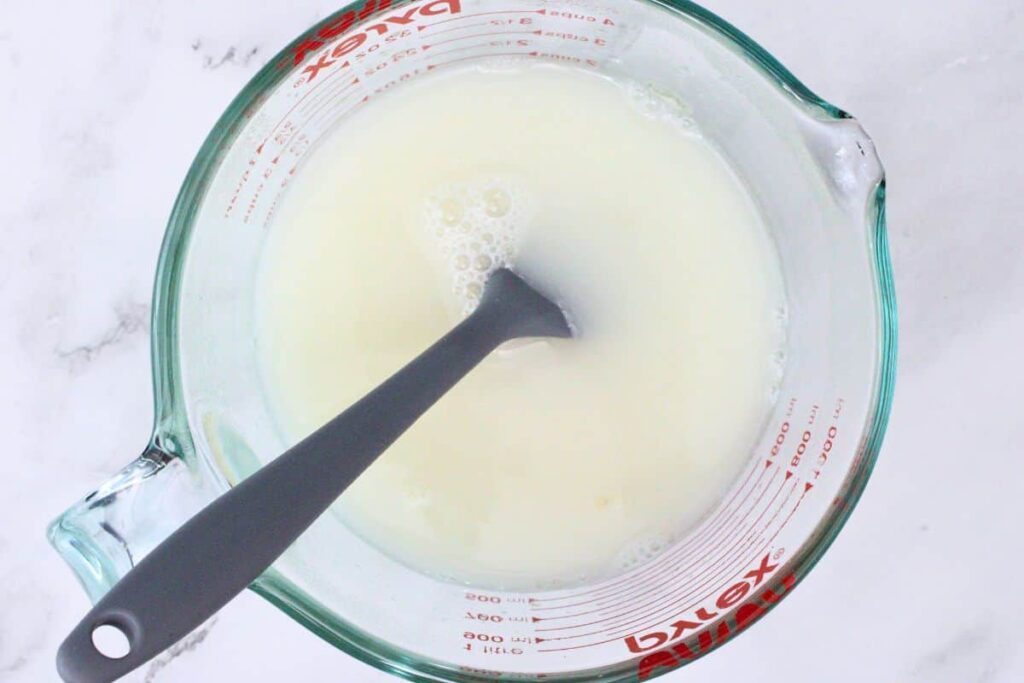 mix unflavored gelatin with boiling water then stir in coconut rum and sweetened condensed milk