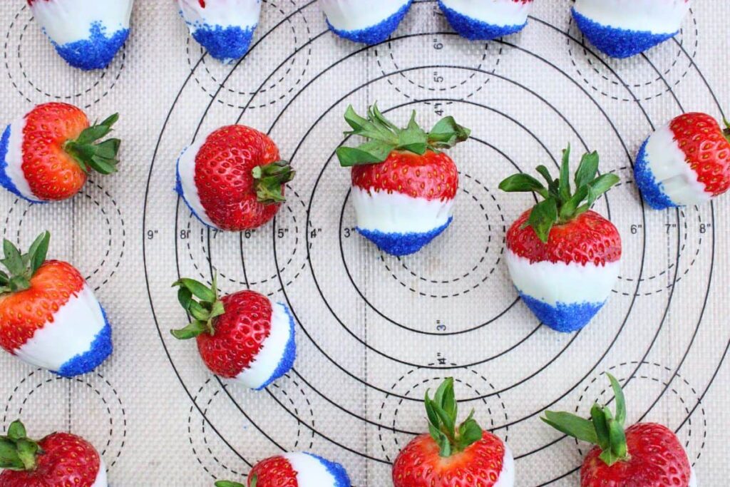 after dipping tips of strawberries in blue sanding sugar line them on your baking sheet