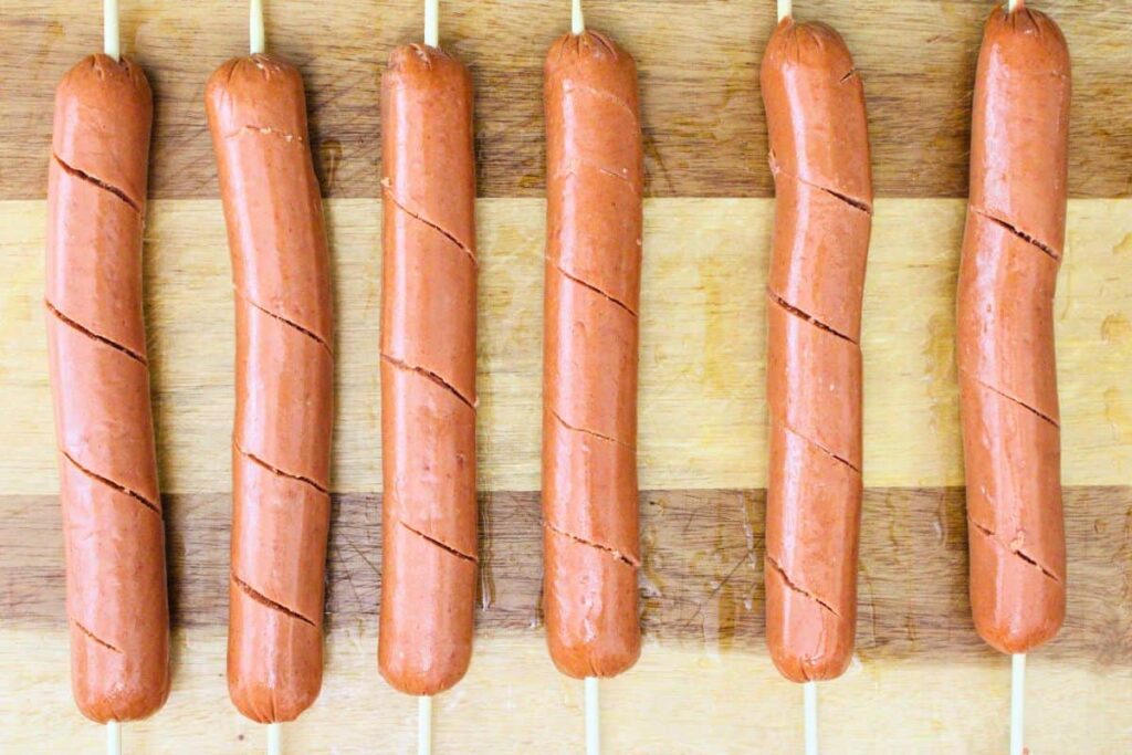 make angled cut through hot dogs while twisting the skewer as you work down the hot dog