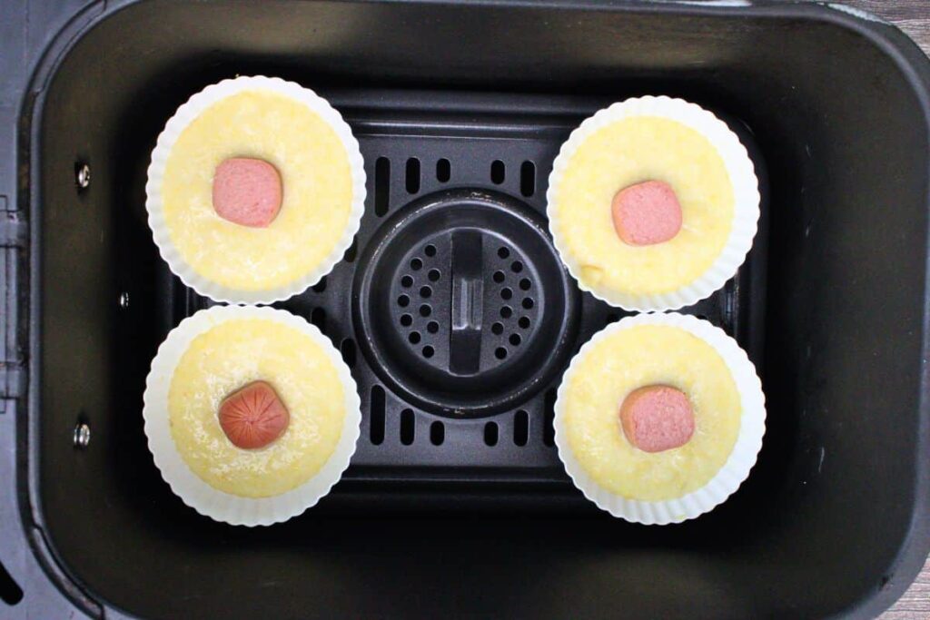 place corn dog muffin cups in air fryer basket