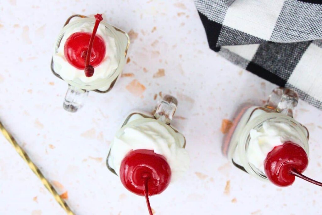 top root beer float shots with whipped cream and cherry