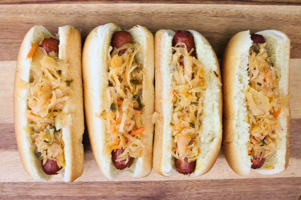 add air fried hot dogs to buns and top with kimchi
