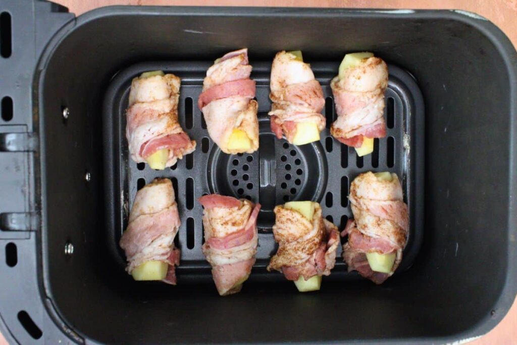 place bacon wrapped apple slices in air fryer basket