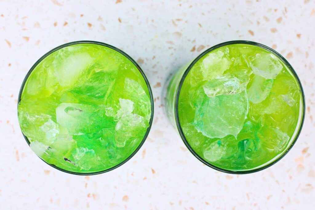 slowly pour blue curacao on top of tipsy mermaid drink