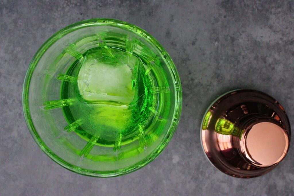 add midori and peach schnapps to cocktail shaker