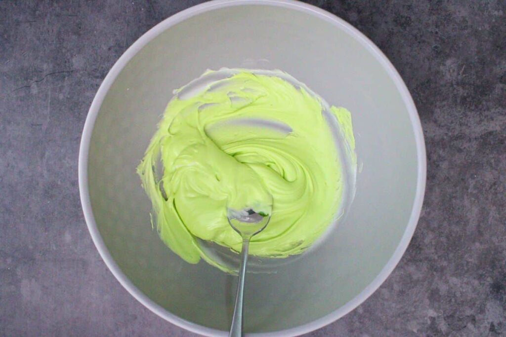 melt white chocolate chips in microwave safe bowl and tint with green food coloring