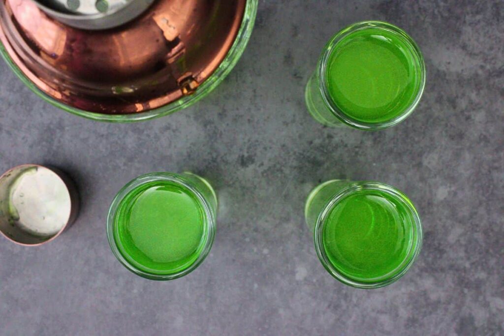 shake and strain green ghostbusters shot mixture into shot glasses