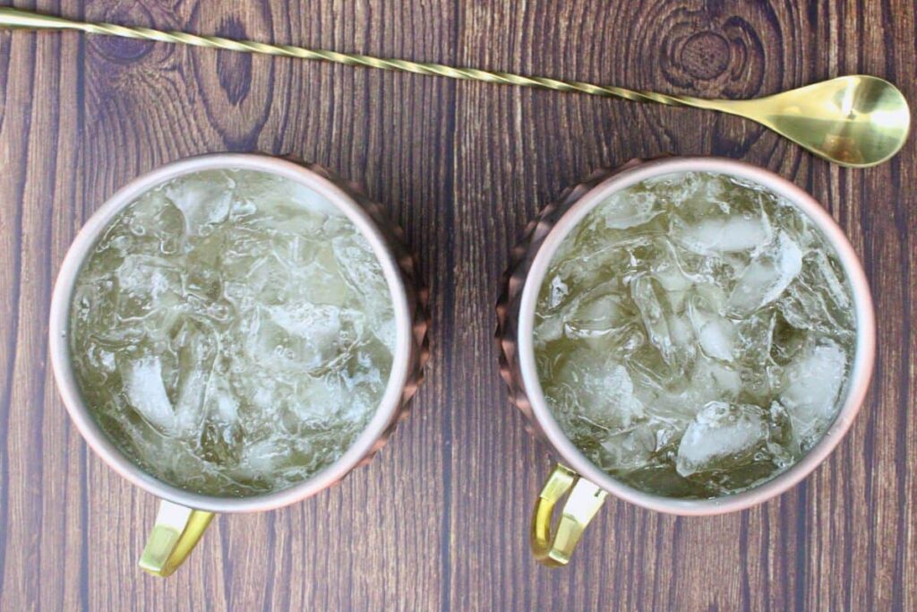 add chocolate whiskey, bitters, and top with ginger beer