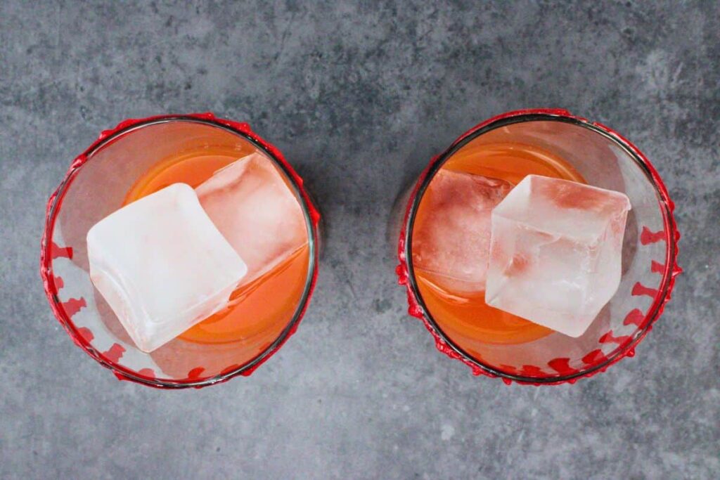fill glass with ice blood orange juice and tequila