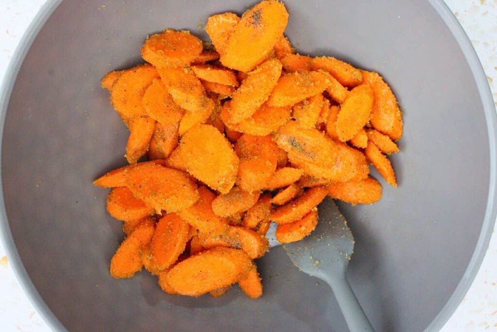 toss carrots in olive oil, brown sugar, salt, and pepper