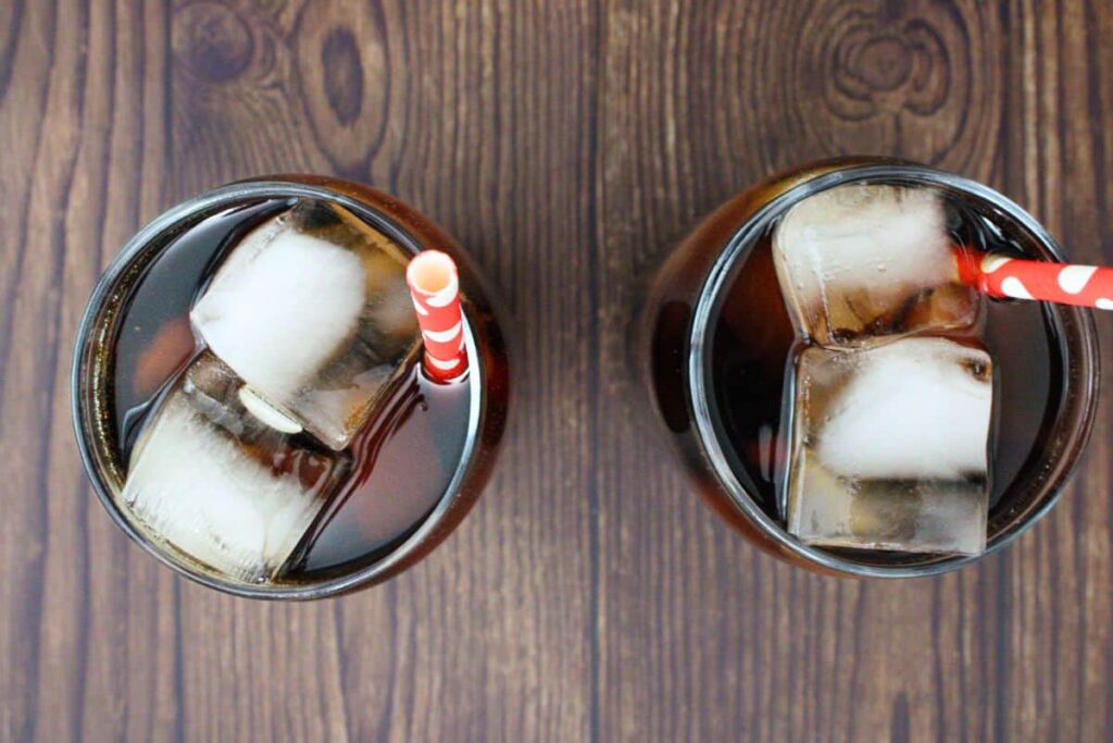 use a straw to gently stir chocolate crown and cherry coke drink