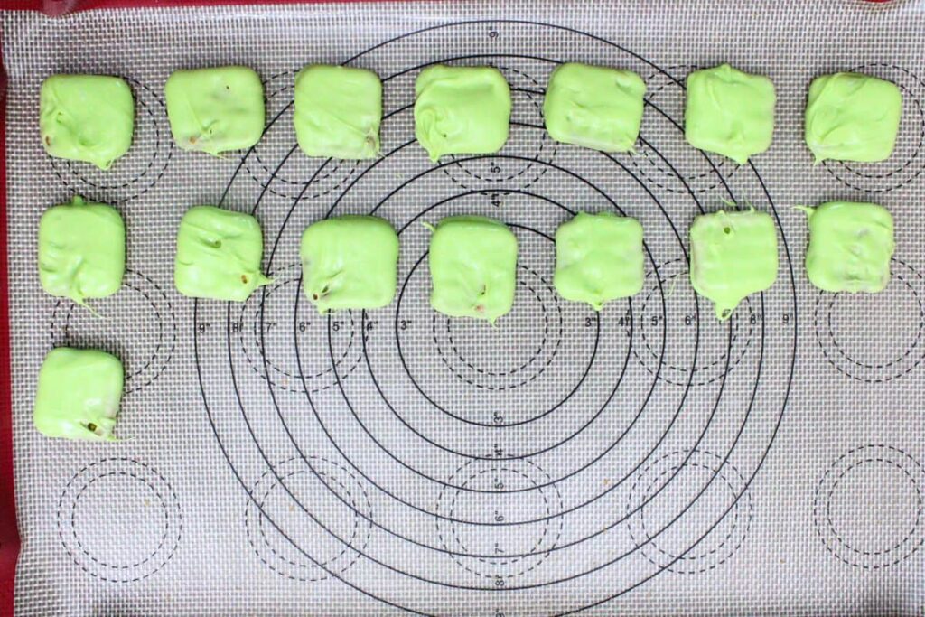 dip pretzel squares in melted green chocolate