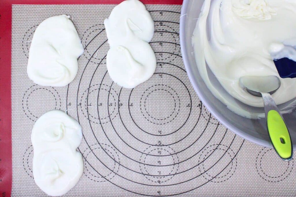 drop spoonfuls of melted chocolate on baking mat
