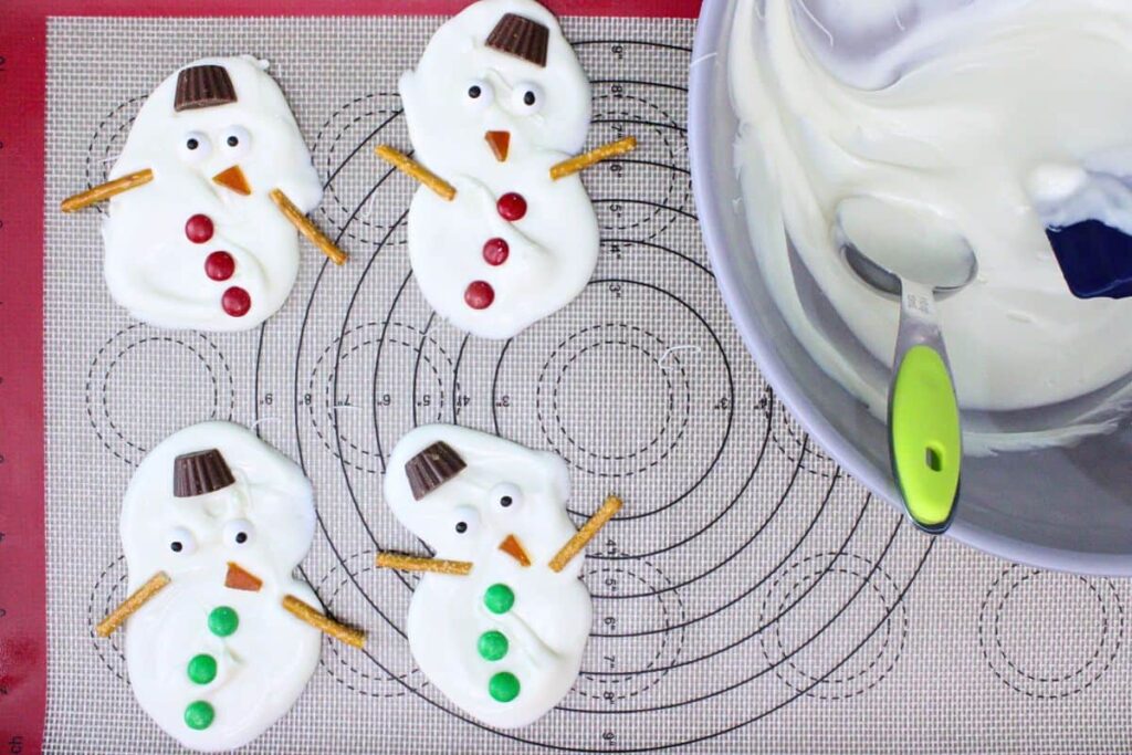 while chocolate is wet decorate the snowman with candies and chocolate