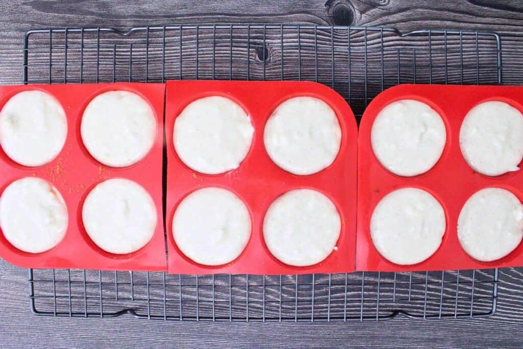 divide eggnog cheesecake batter over crusts