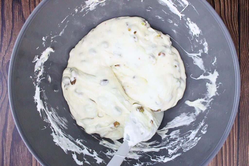 fold in honey and pistachios to marshmallow mixture