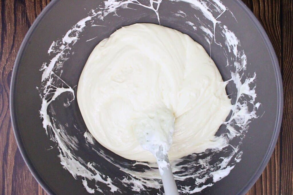 melt marshmallows with white chocolate chips and butter in a large microwave safe bowl