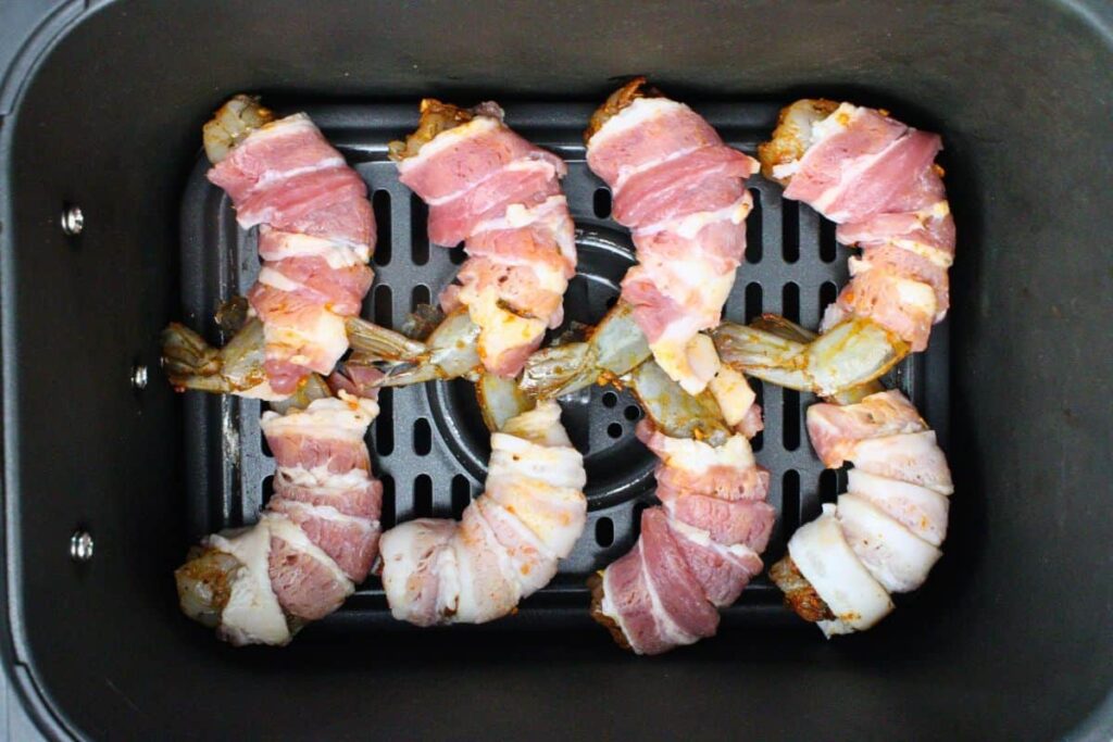 place bacon wrapped shrimp in air fryer basket