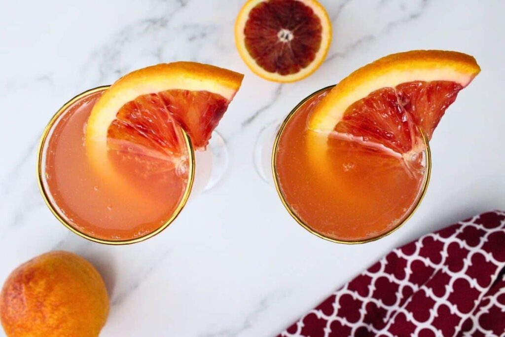 overhead view of blood orange mimosas garnished with blood orange slice